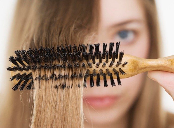 Close up of hairbrush in woman?s hair