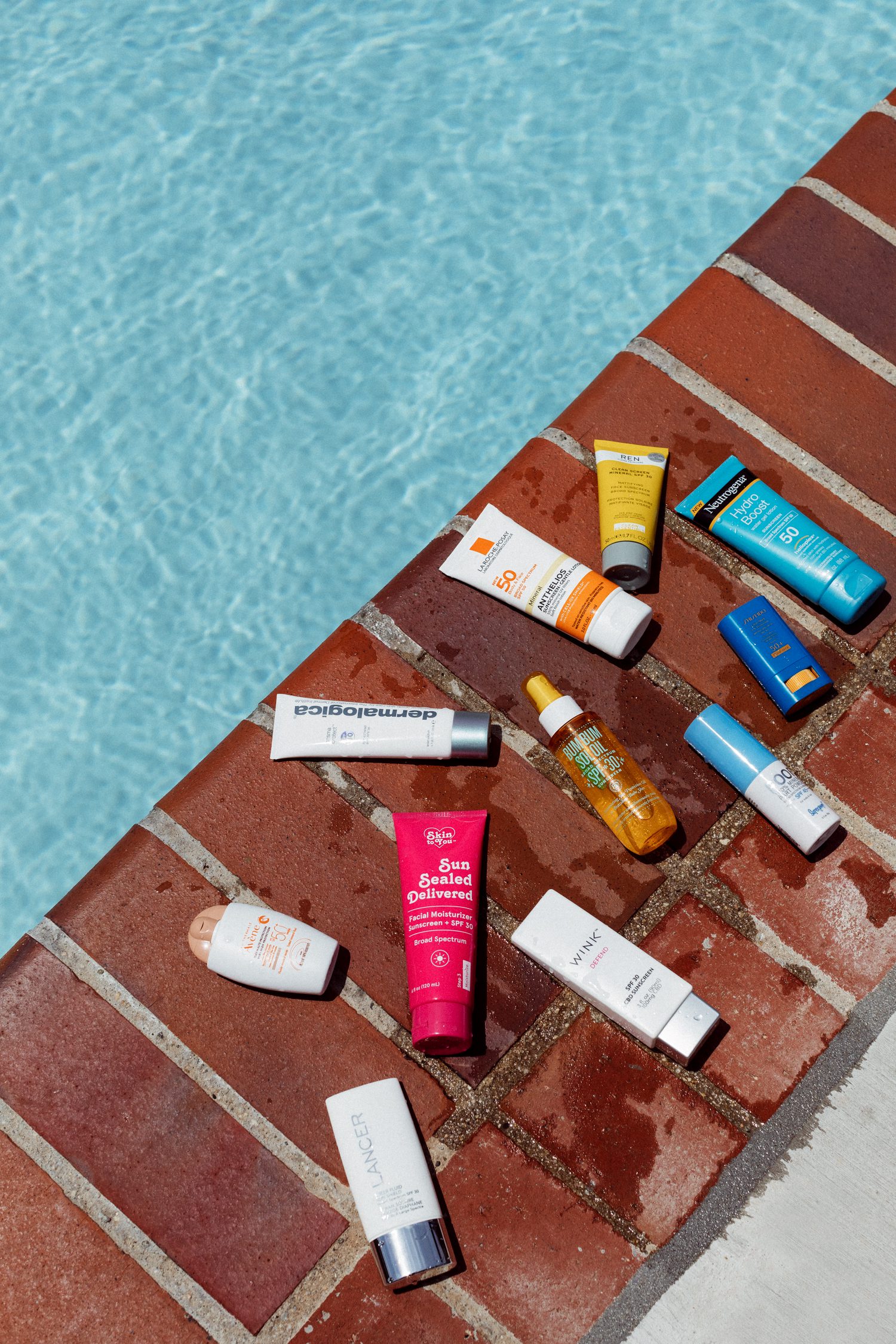 An array of sunscreen by the pool
