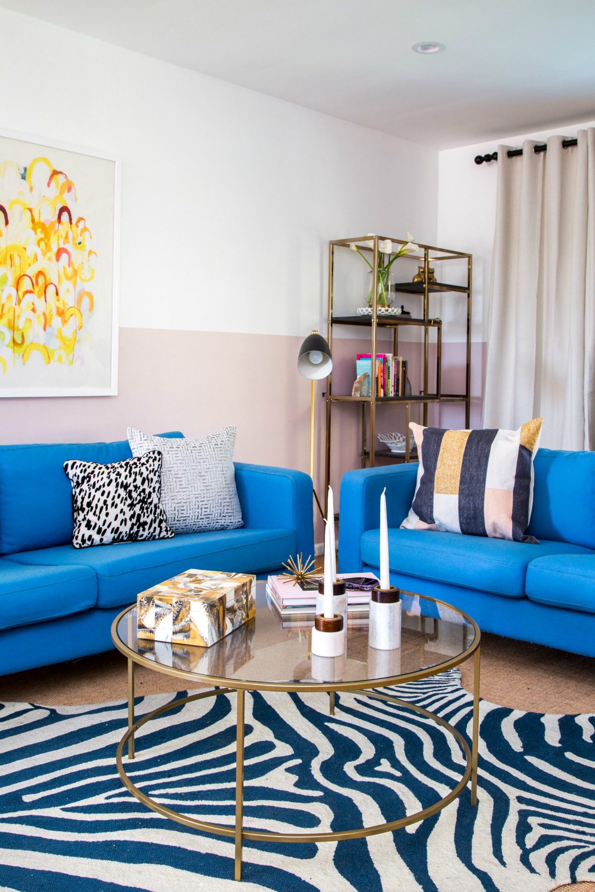 living room apartment tour showing two blue couches and center table