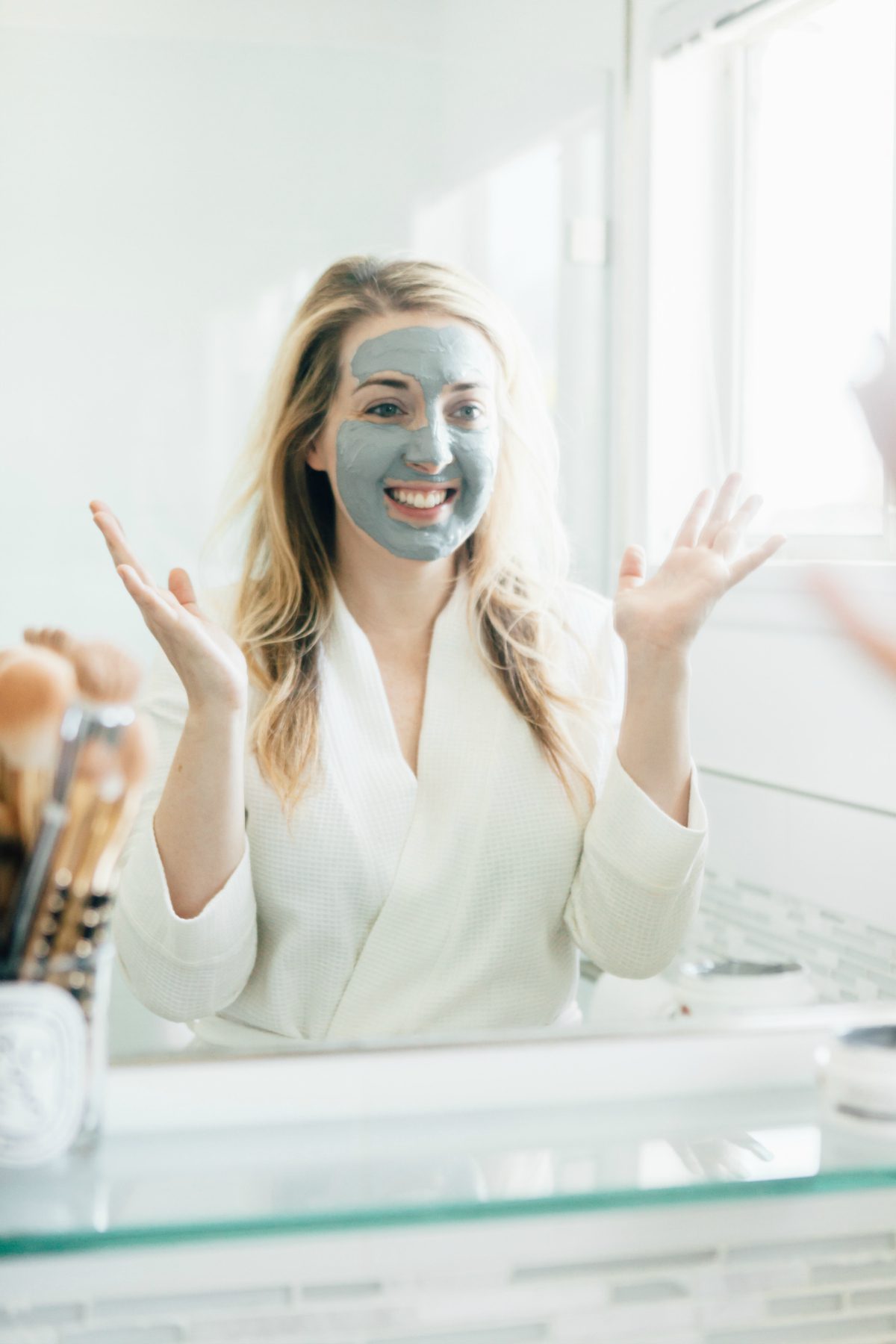 woman using Tree Hut Skincare exfoliating mud mask 