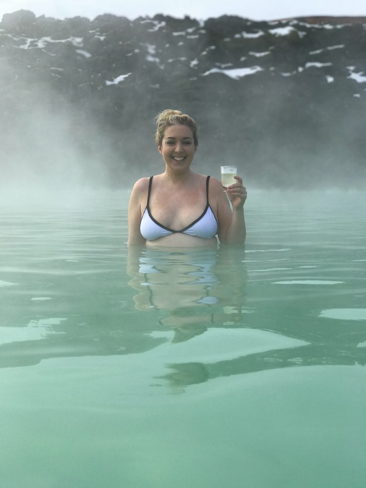 woman in blue lagoon and sharing why Iceland is the Ultimate Beauty destination
