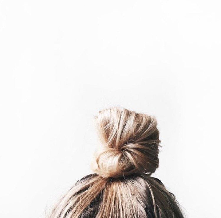 woman's hair in a bun for shampoos and conditioners for fine hair