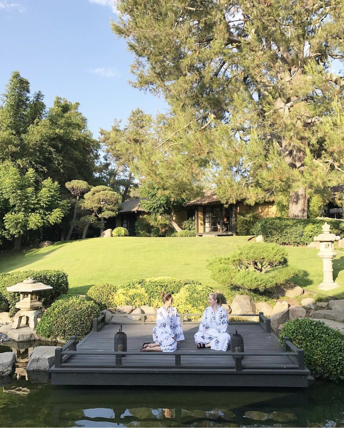 two women sitting near the pond at Golden Door Spa