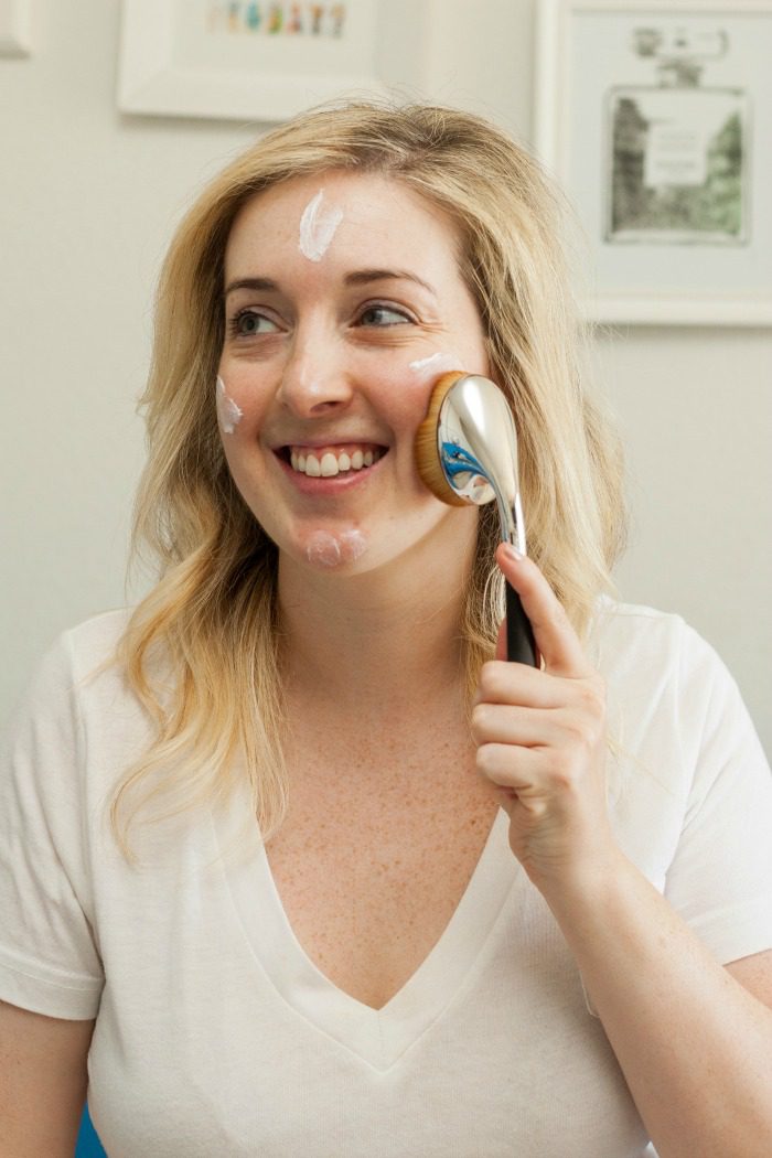 woman applying the best daily moisturizer for sensitive skin