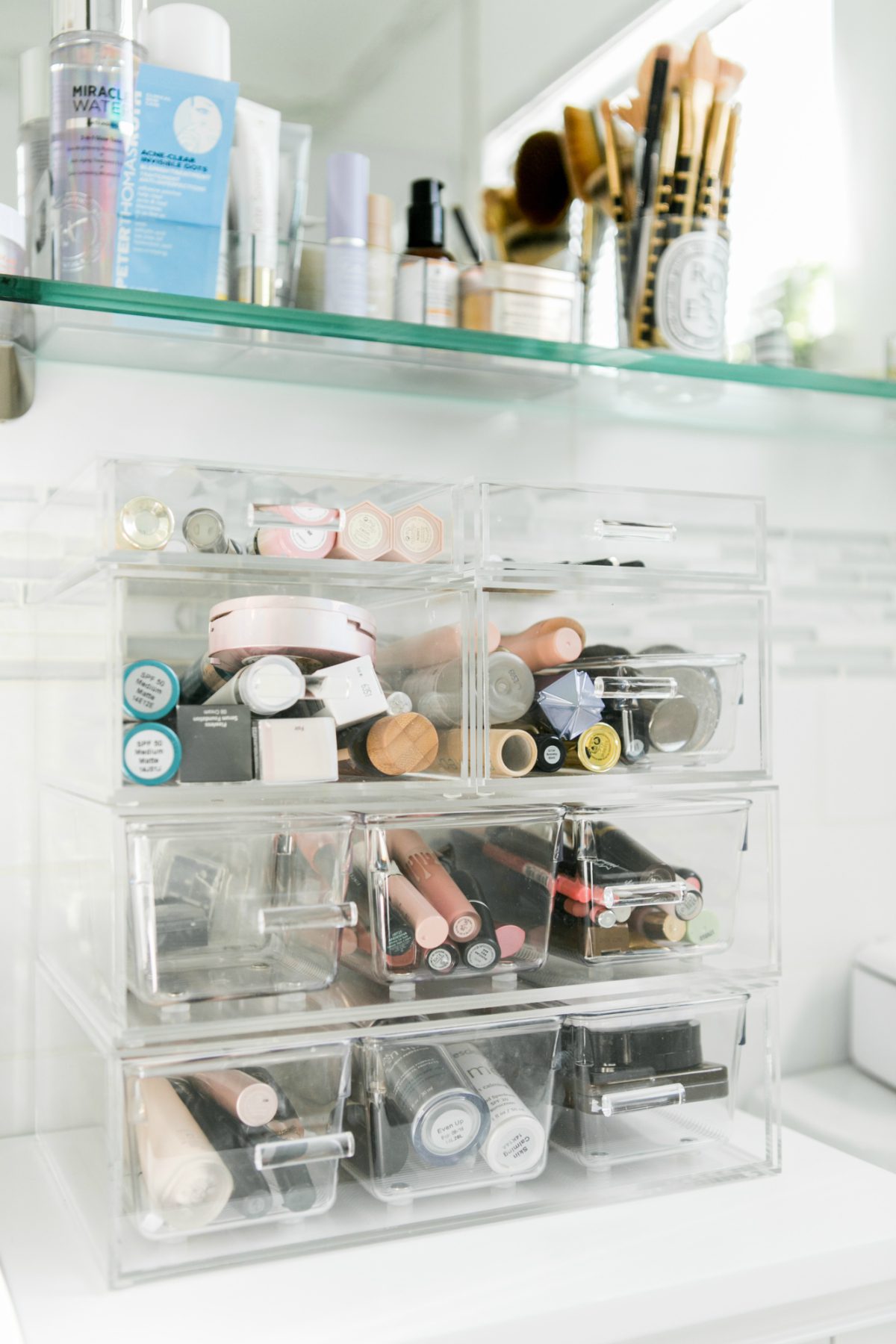 organized beauty products in a bathroom using clear containers