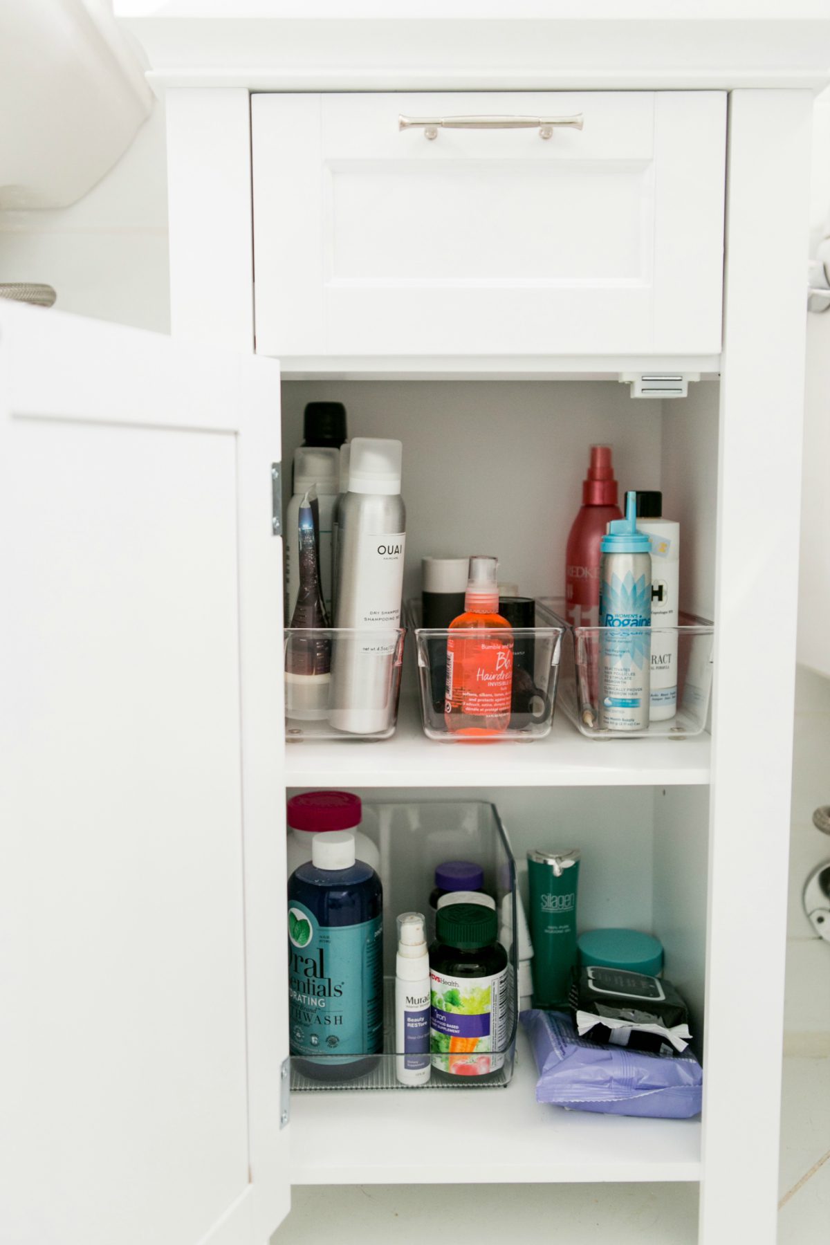 white drawer with clear containers with beauty products 
