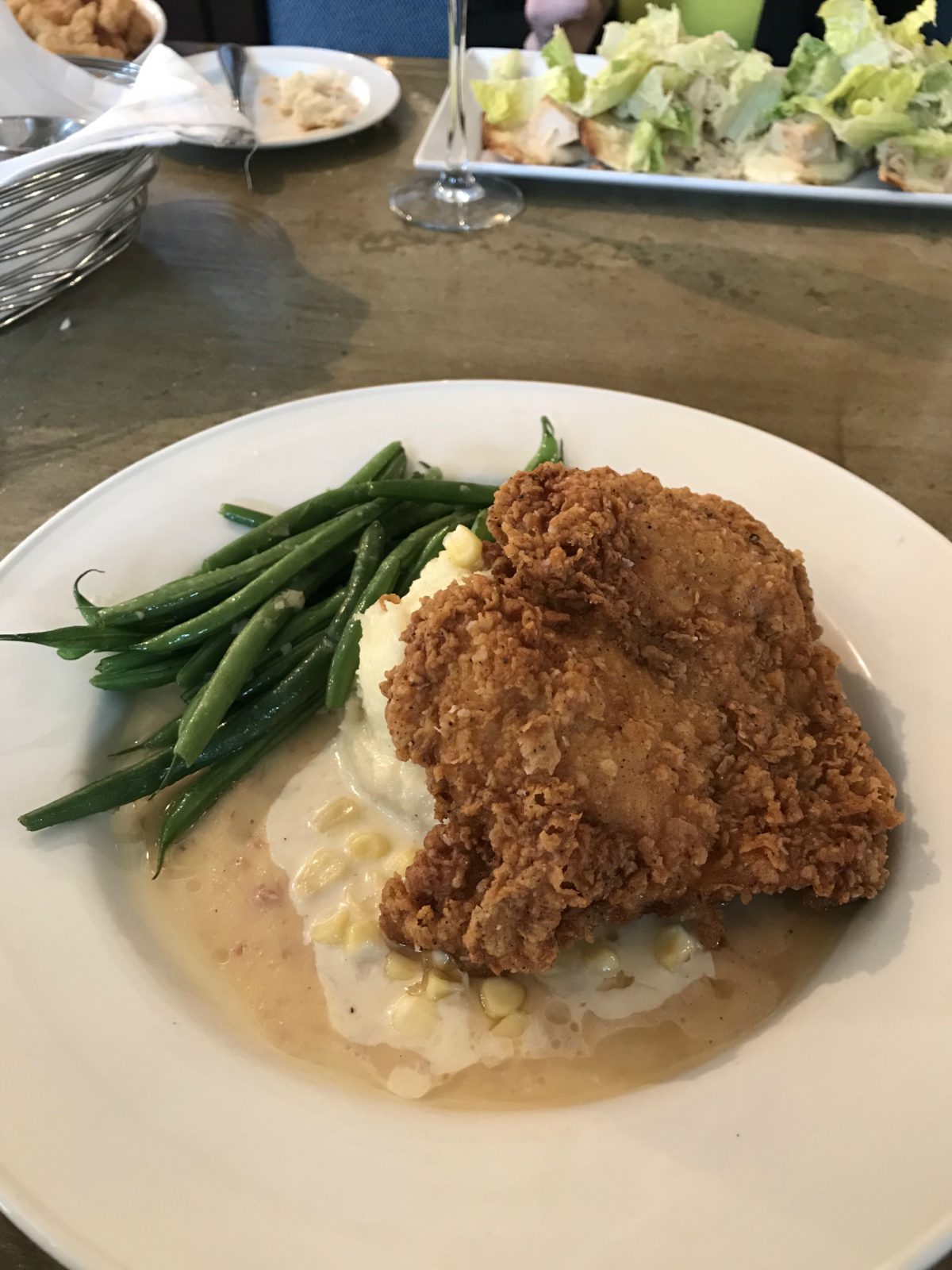 plated meal with chicken, beans, and potato for Charleston Travel Guide