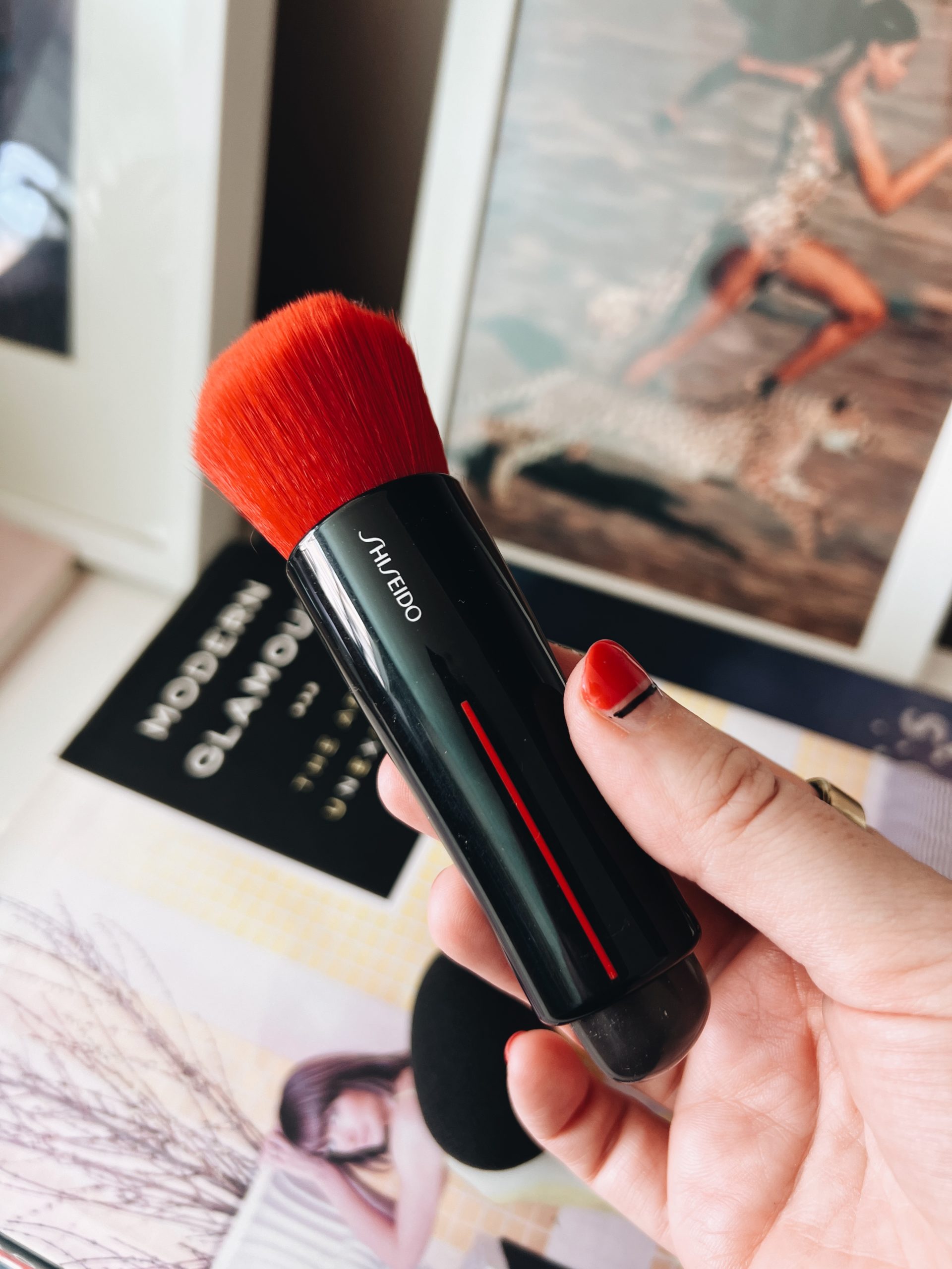 woman showing Makeup Brush VS Beauty Blender 